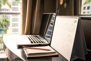 Calendar 2021 schedule with blank note for to do list on wooden desk